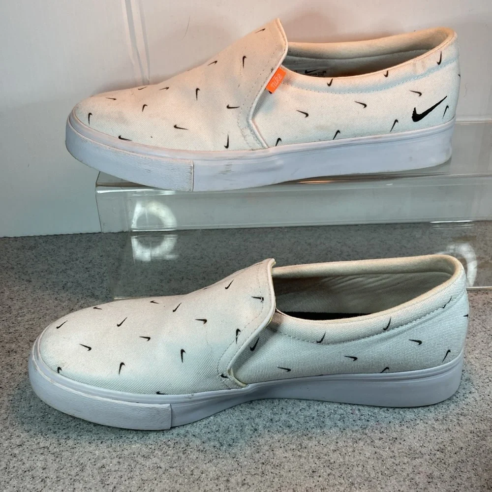 Size 9.5 Nike white slip on surfer skater‎ style with swooshes all over. 5